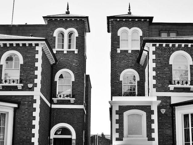 A split image of a cozy suburban home on one side and a modern, high-rise apartment building on the other, symbolizing the range in residential real estate.